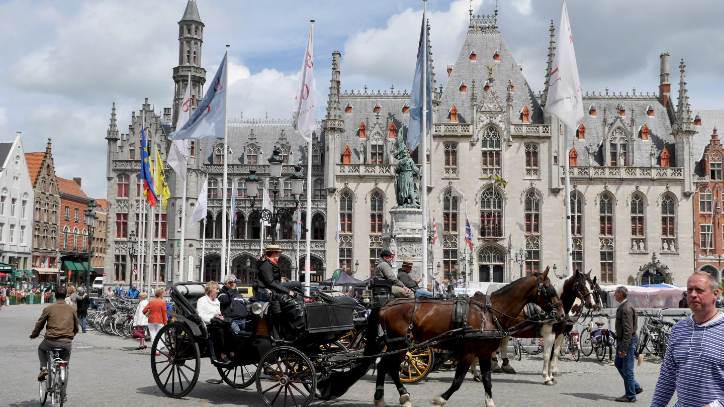 Horses are waiting for customers in the market of Bruges