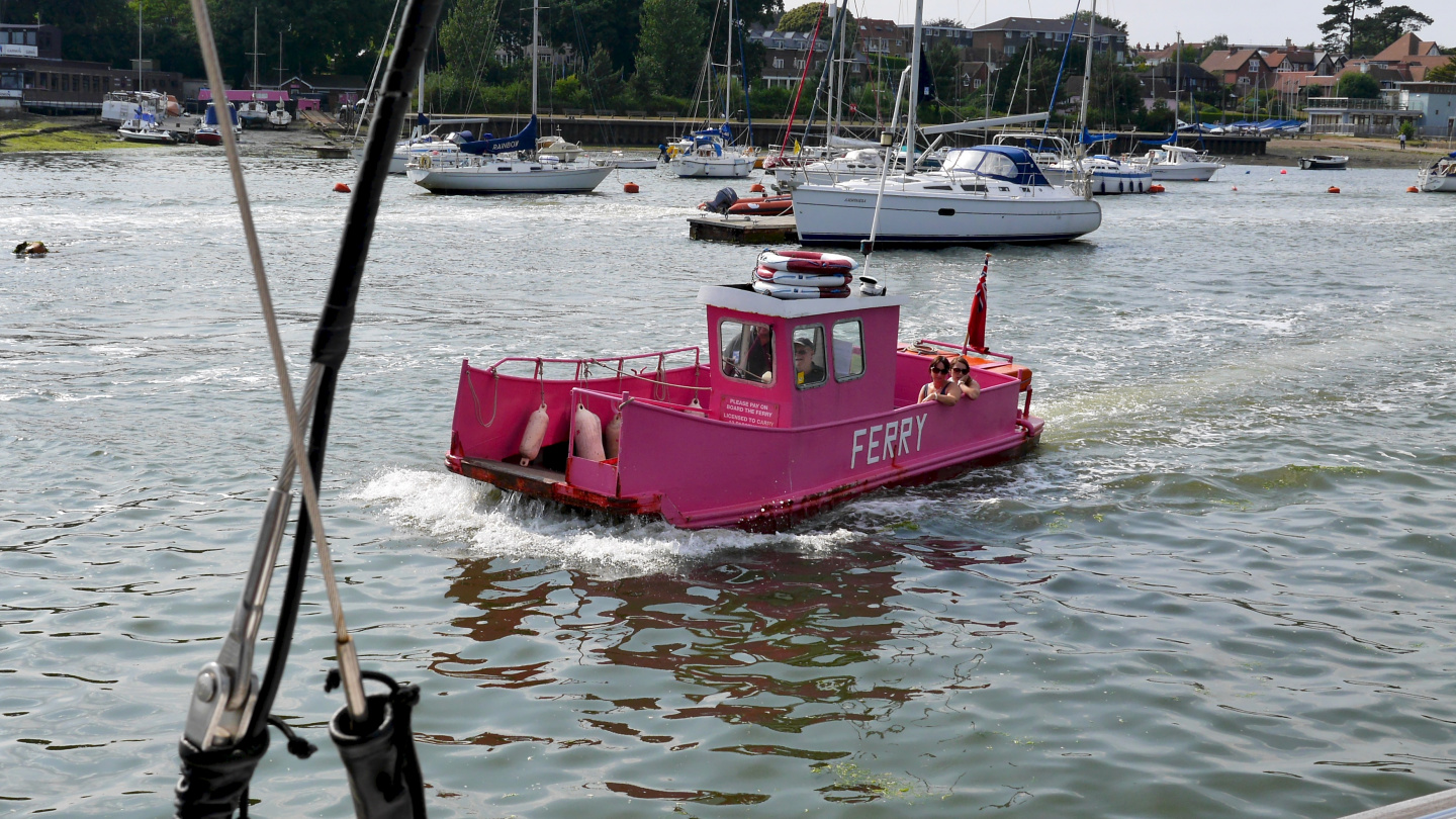 Cute miniature ferry crossing the river Hamble