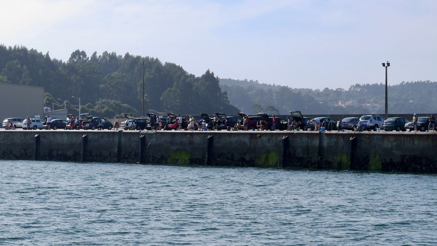 Men fishing in the harbour of Sada in Spain