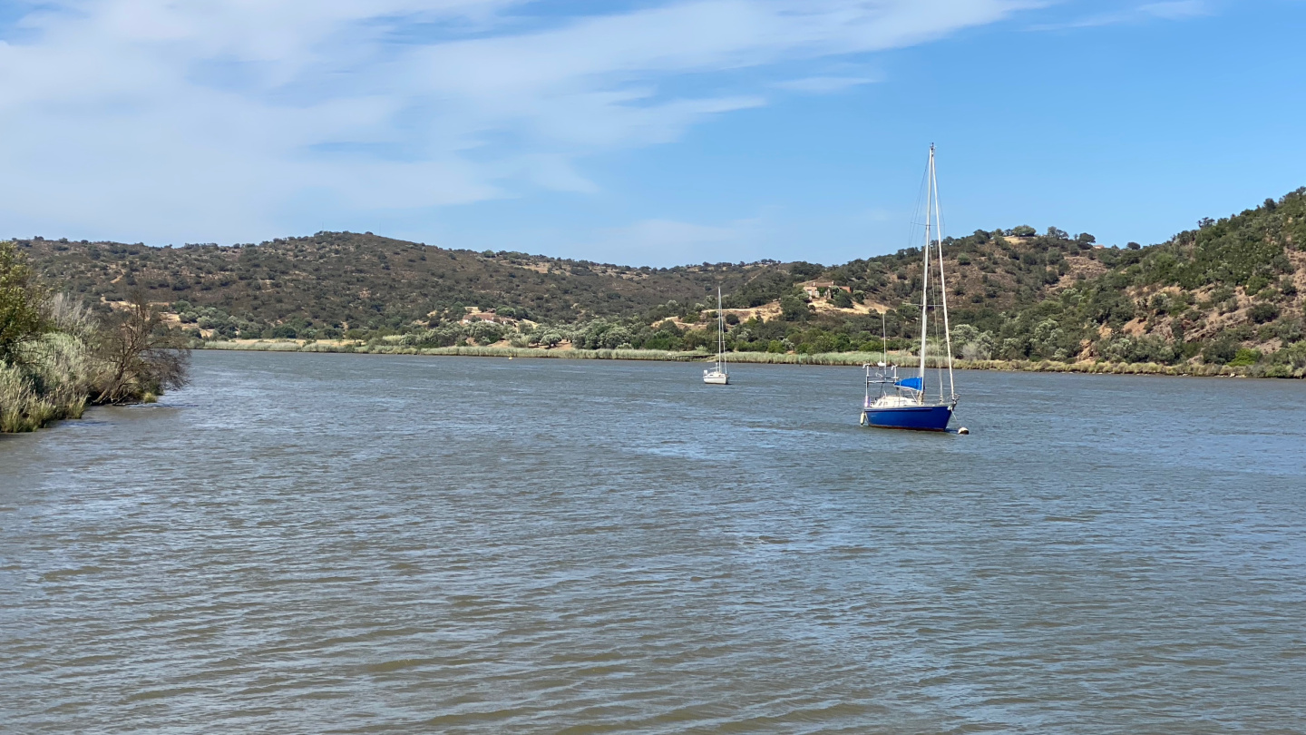 Boats moored in front of Foz de Odeleite on the river Guadiana